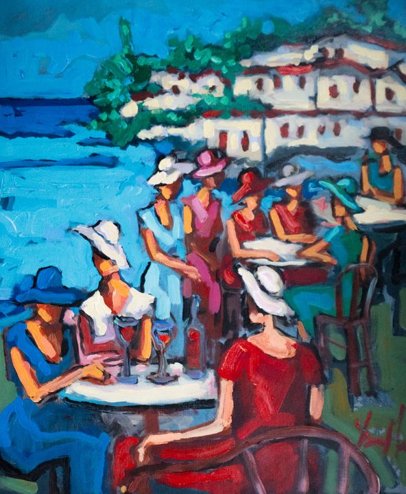 Women in summer hats at a seaside café